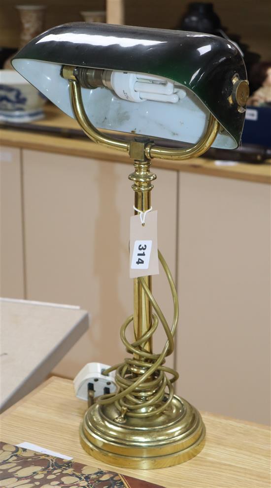 A brass desk lamp with green glass shade